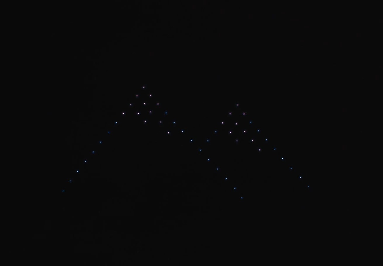 The same mountains flown at night by fifty drones over Manfeild, each drone a point of light.